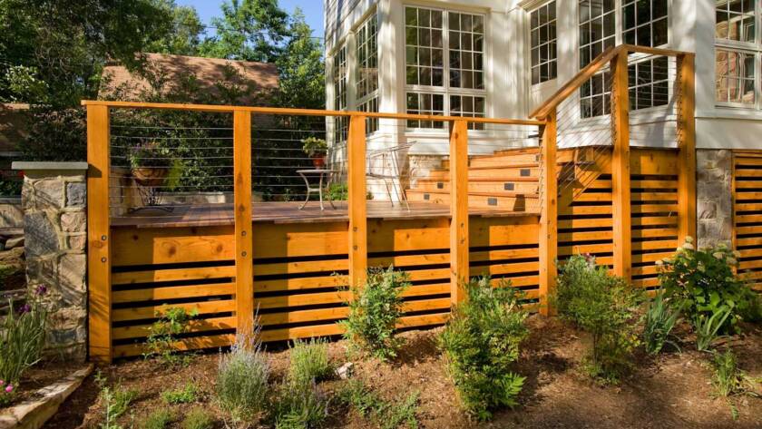 Deck skirting installation outside a home with small plants and grass—Truhome LLC PA home improvement services.