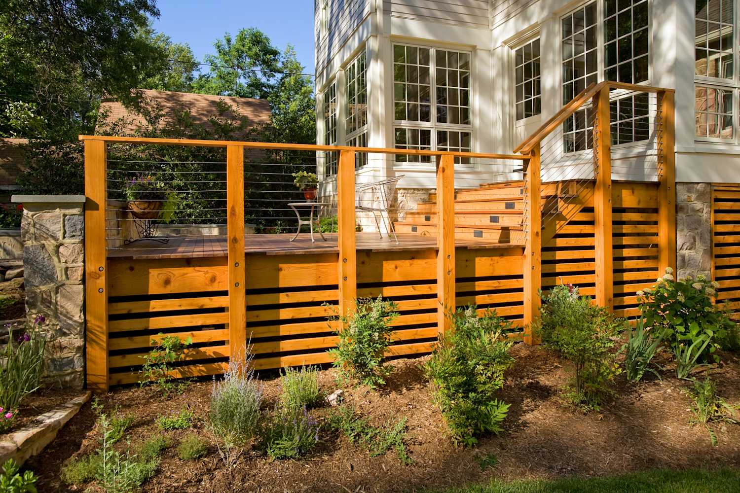 Deck skirting installation outside a home with small plants and grass—Truhome LLC PA home improvement services.