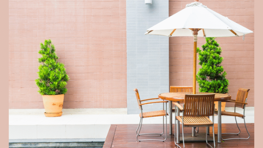 Modern patio renovation by a home improvement company in PA, featuring stylish outdoor furniture, potted plants, and a sunshade umbrella – perfect for homes in Mount Pleasant, PA.